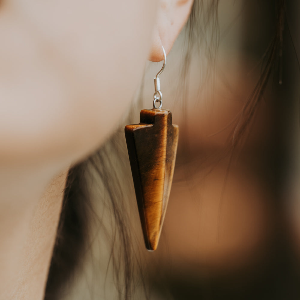 woman wearing stone dangle earrings