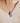 woman wearing teardrop pendant necklace