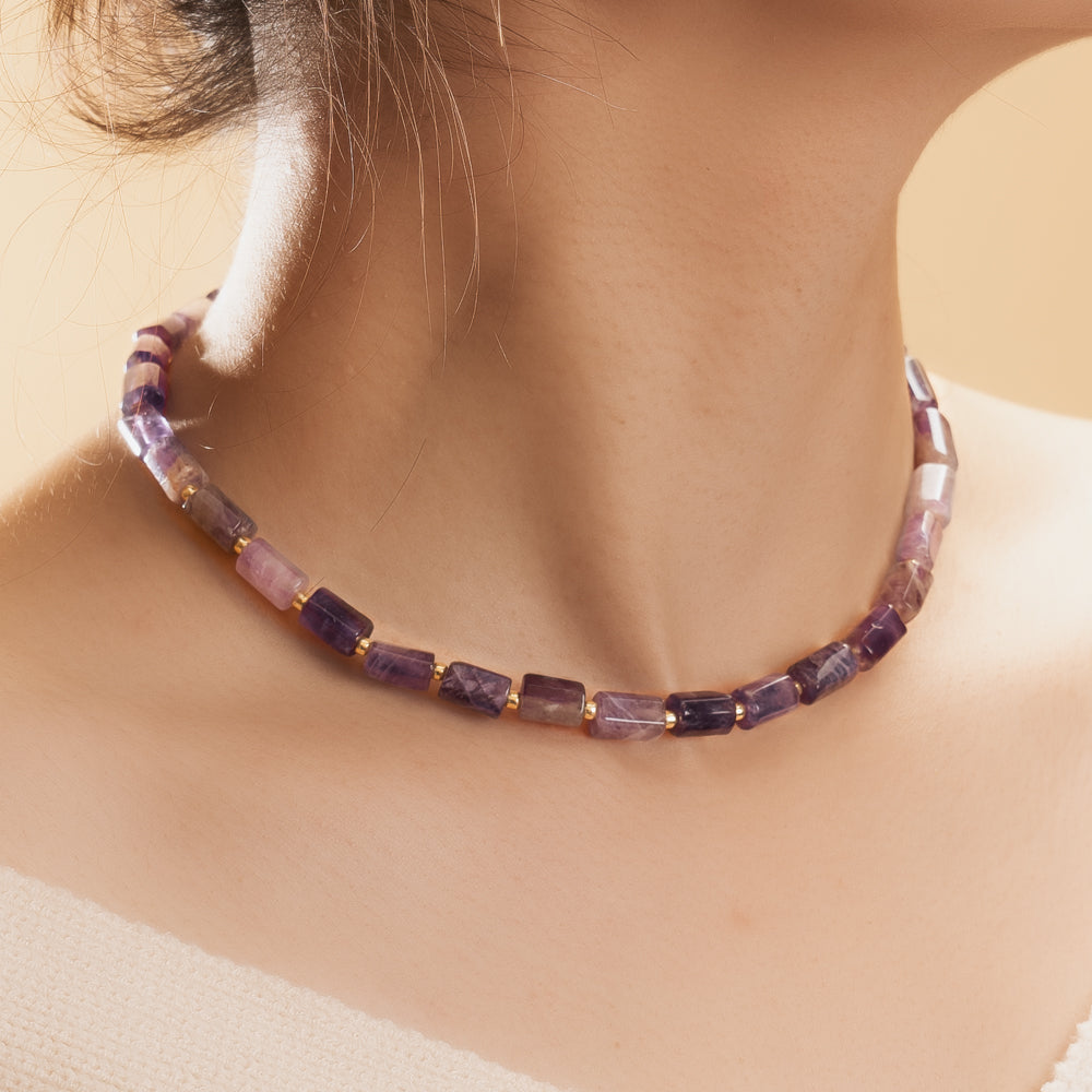 woman wearing purple stone necklace