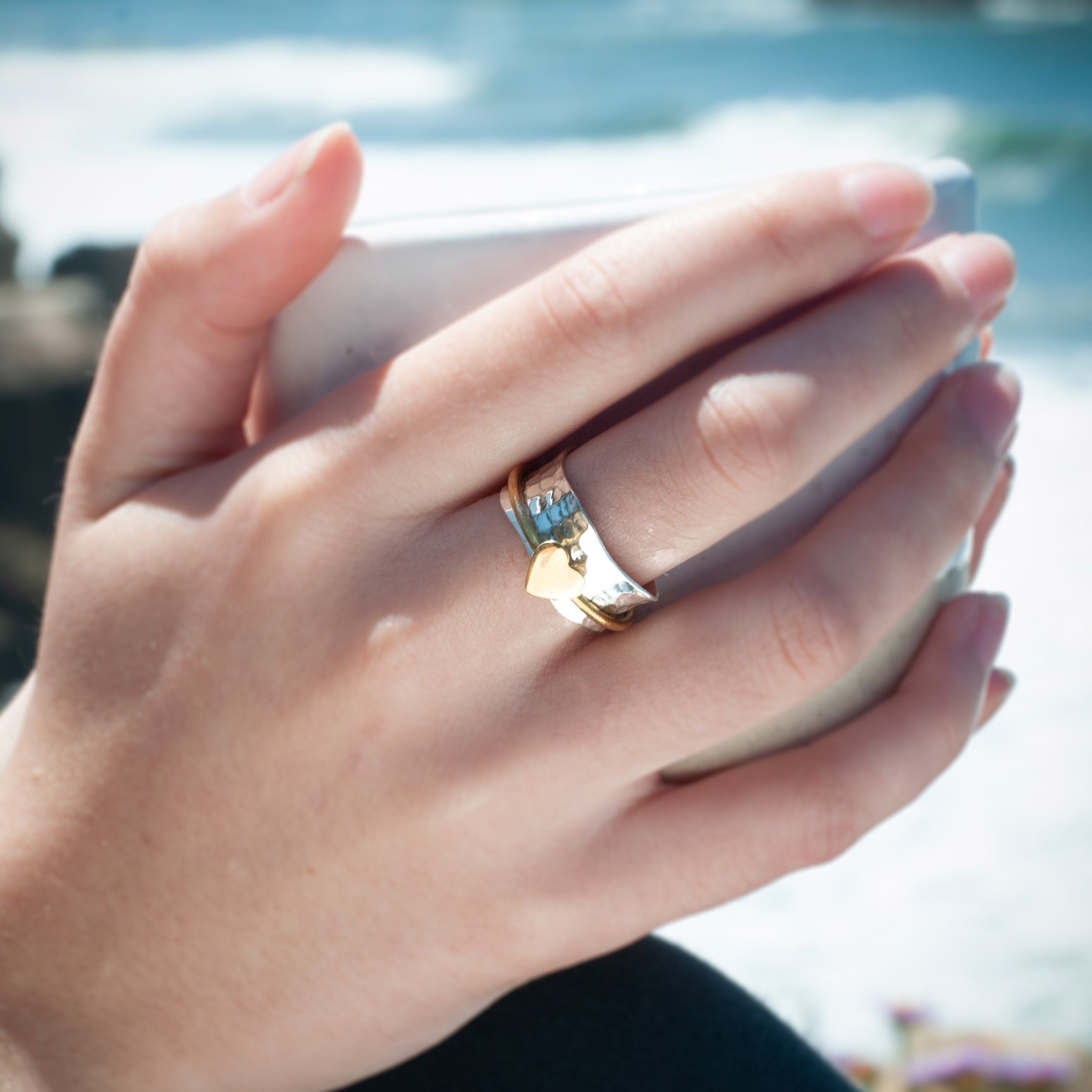 woman wearing heart spinner ring