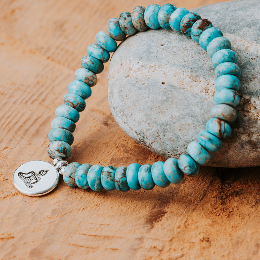 Blue Turquoise stone beads and a silver charm in a stackable gemstone bracelet handmade by Treehut