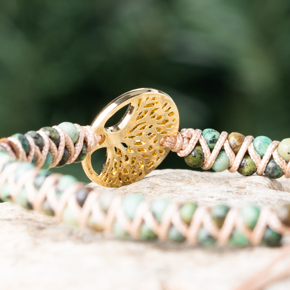 Gold tree of life charm bracelet with natural deep green jasper stones in a stretchable single strand bracelet