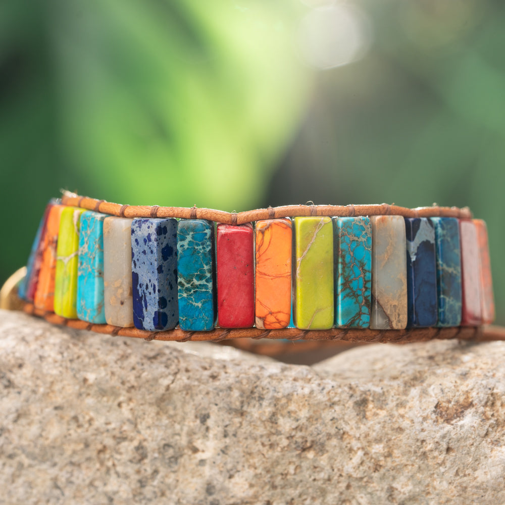 Treehut's handmade vibrant bracelet crafted from natural imperial jasper stones in a tube shape, held together with a genuine leather strap.