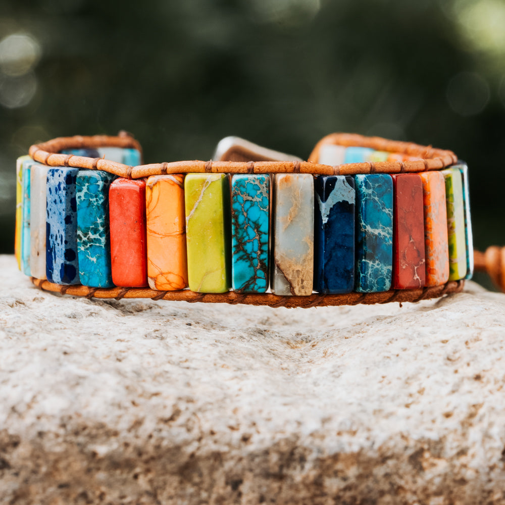 Add a pop of color to any outfit with this striking natural stone bracelet, featuring a tube-shaped compilation of imperial jasper stones and a genuine leather strap by Treehut