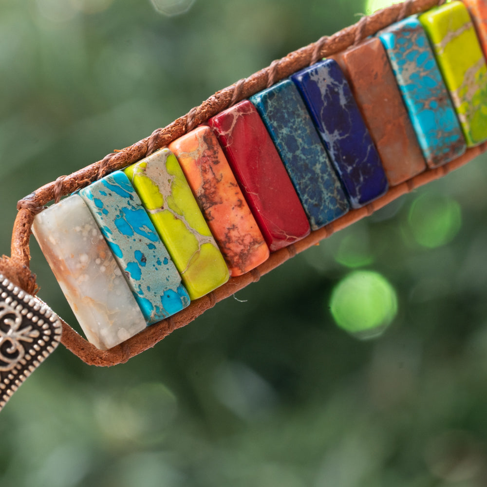This fashion-forward bracelet is the perfect way to showcase your unique style, featuring a colorful arrangement of natural imperial jasper stones on a single wrap leather band