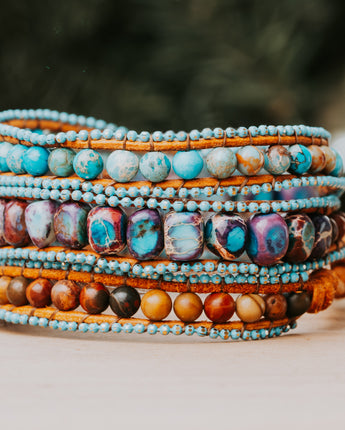 A stunning bracelet crafted from sea sediment jasper stones in a variety of blue and purple hues handmade by Treehut
