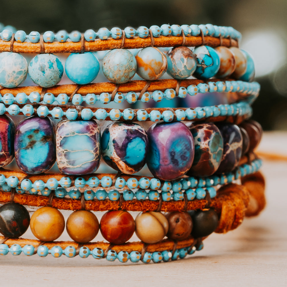 A beautiful bracelet made from sea sediment jasper stones in various blue and purple tones, perfect for adding a pop of color to any outfit