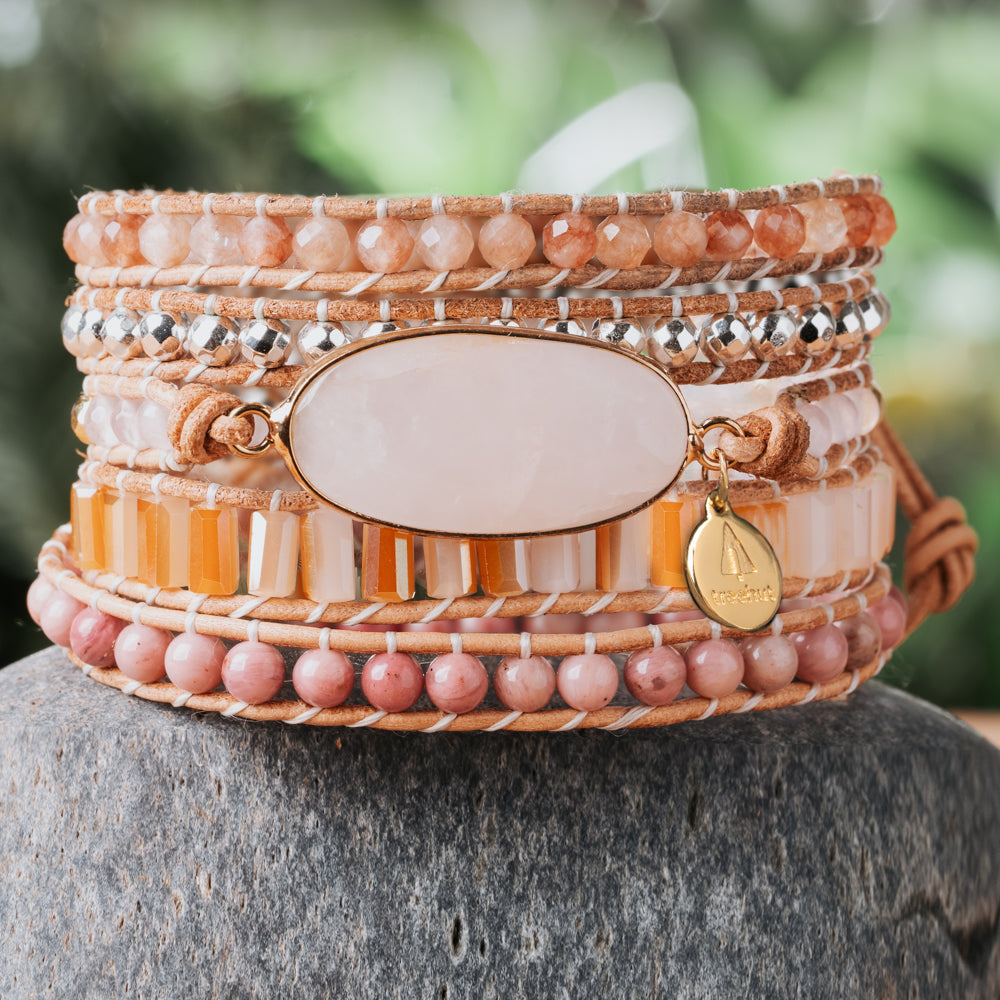 Pink and orange natural stone five leather wrap bracelet with rose quartz crystal and rhodonite stone beads.