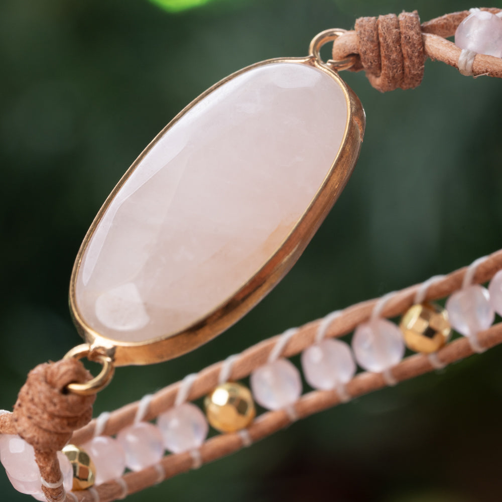 Healing pink rose quartz crystal with five leather strands. Handmade Treehut bracelet for women