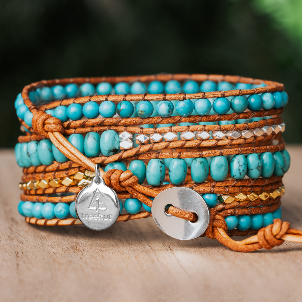 Add a touch of elegance to your outfit with this five-wrap bracelet, featuring natural Turquoise stone and Sterling Silver nuggets on earthy-toned leather