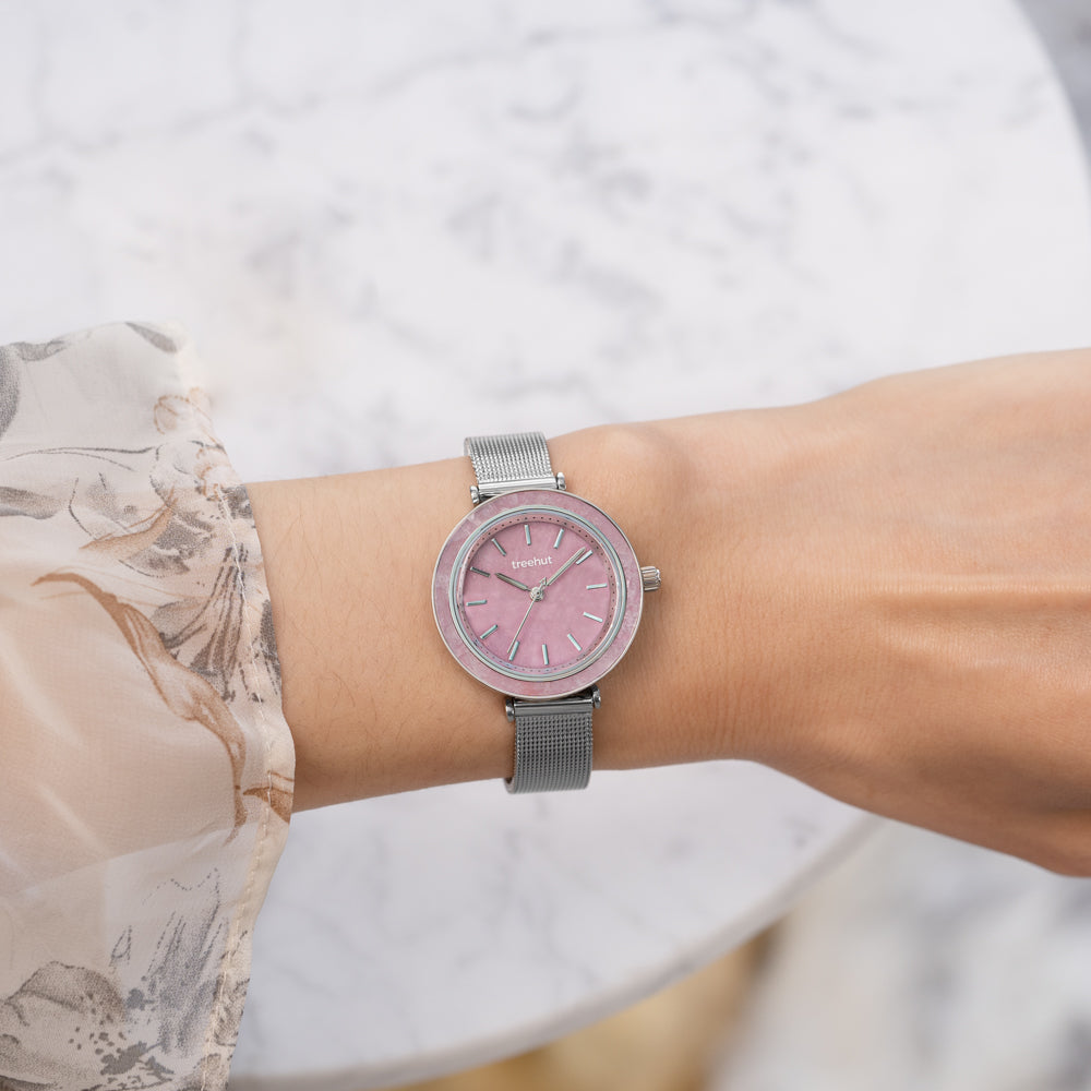 woman wearing pink dial watch