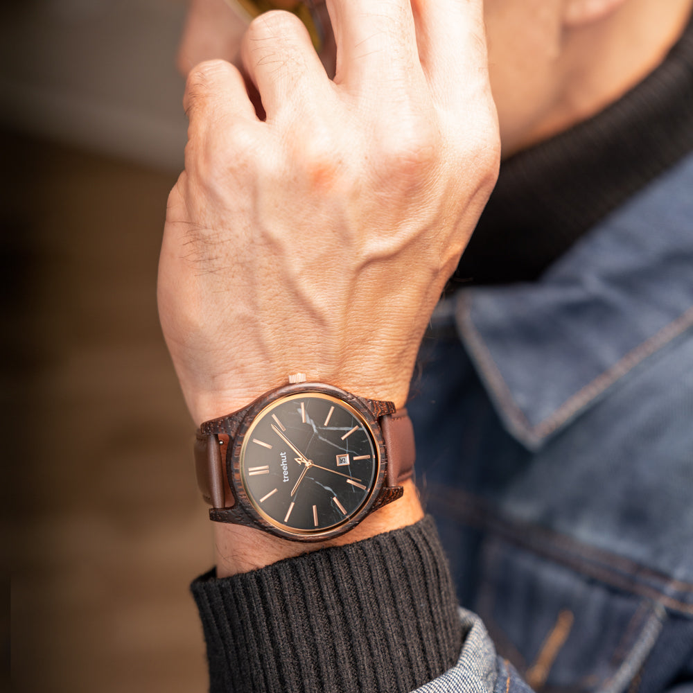 black dial watch with brown leather band