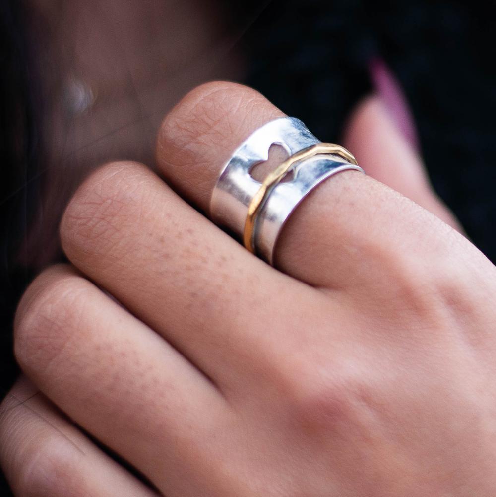woman wearing heart spinner ring