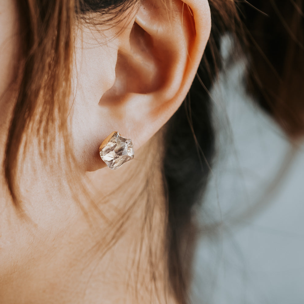 woman wearing crystal stud earrings