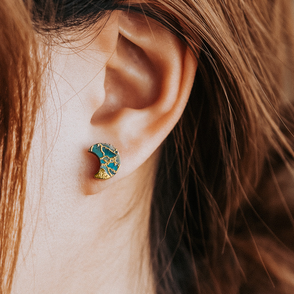 woman wearing turquoise stud earrings