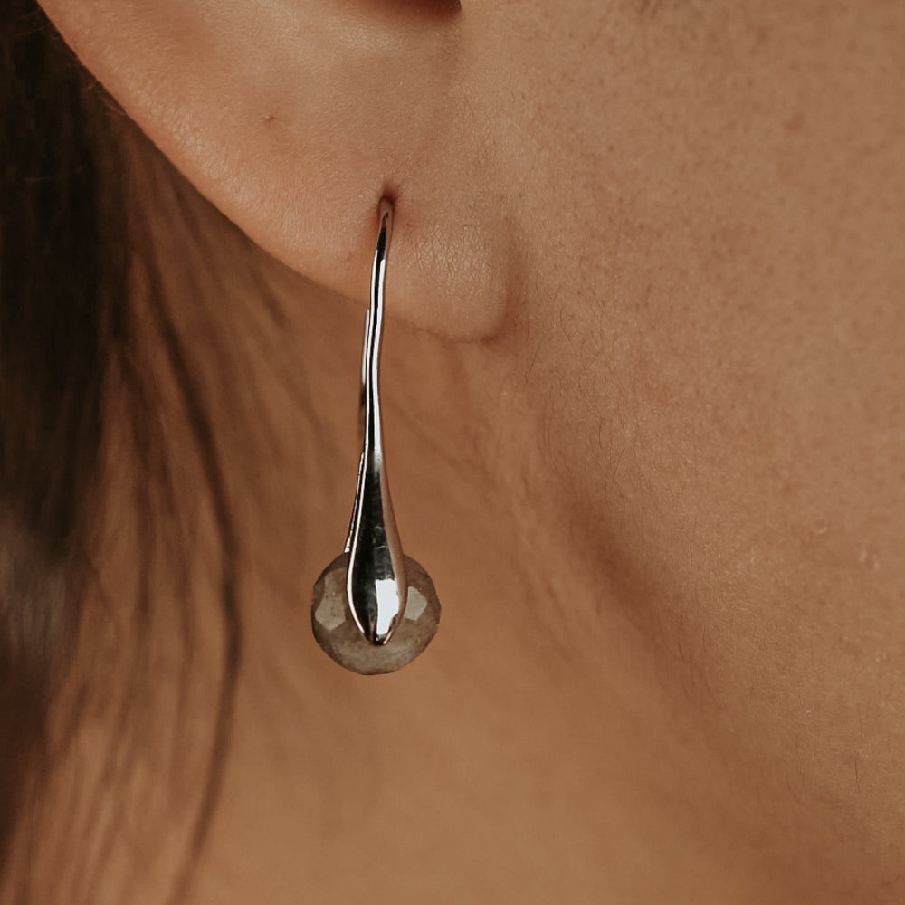 woman wearing labradorite earrings