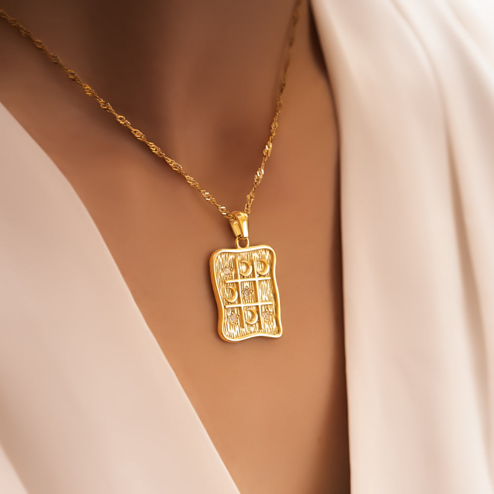 woman wearing square pendant necklace