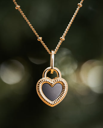 Heartshaped gold plated double sided black and white necklace