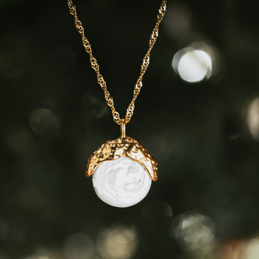 Gold and white pearl shell necklace with twisted gold necklace