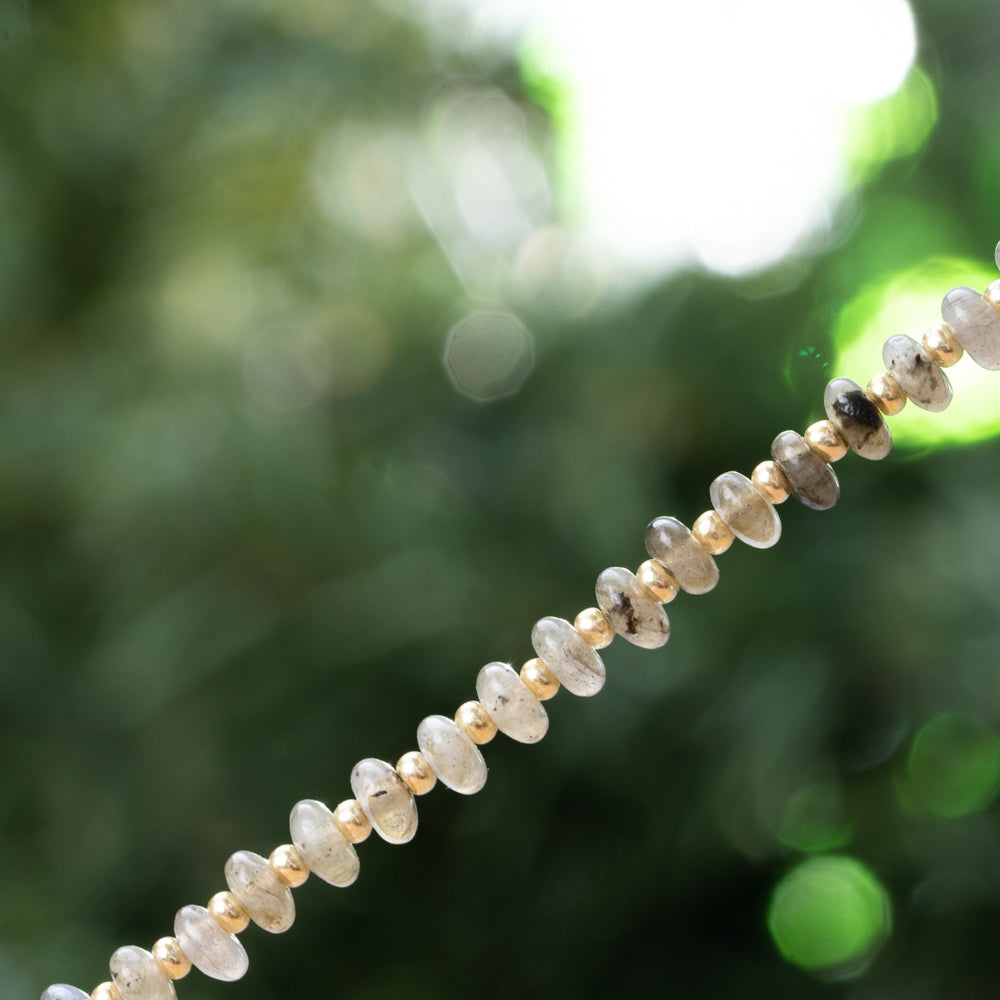 Grey and gold choker with protection stones