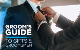 groom tying his groomsman's tie