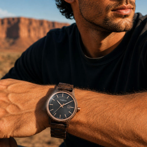 man wearing an ebony wood watch with black dial