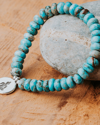 Blue Turquoise stone beads and a silver charm in a stackable gemstone bracelet handmade by Treehut 