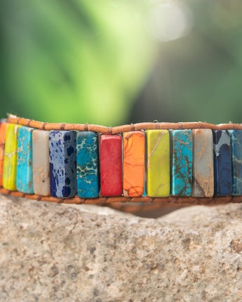 Treehut's handmade vibrant bracelet crafted from natural imperial jasper stones in a tube shape, held together with a genuine leather strap.