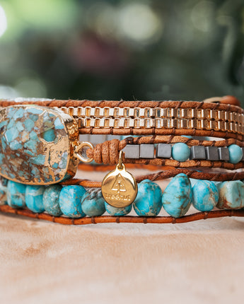 Handcrafted triple-wrap leather bracelet with three layers of natural turquoise stone beads, a chunky center stone, gold bead nuggets, and silver beads by Treehut