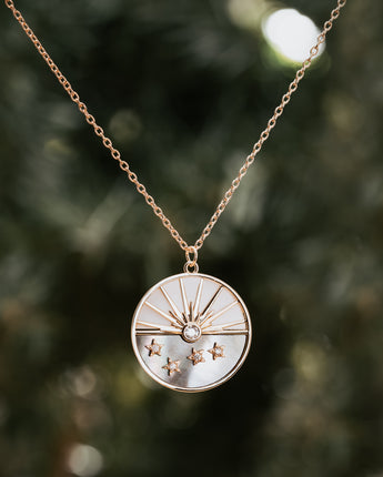 Gold and silver necklace with sun and stars